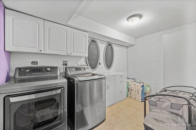 611 Brewster Ln, Schaumburg, IL 60193 - washroom featuring cabinet space, separate washer and dryer, and light tile patterned floors