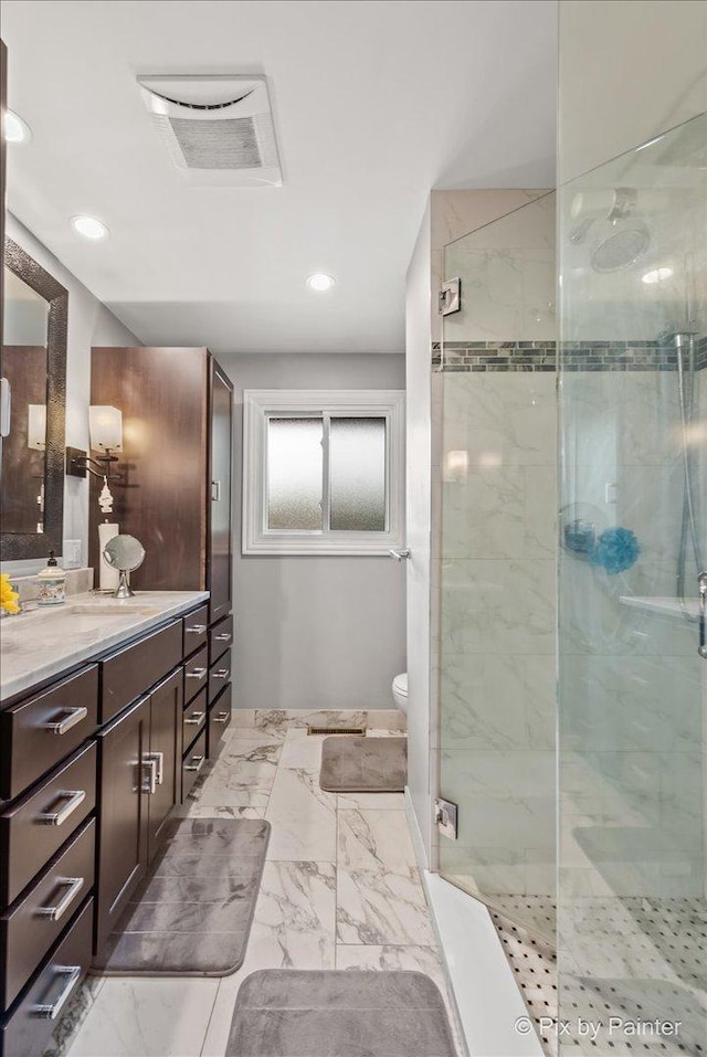 611 Brewster Ln, Schaumburg, IL 60193 - bathroom featuring vanity, a stall shower, marble finish floors, toilet, and recessed lighting