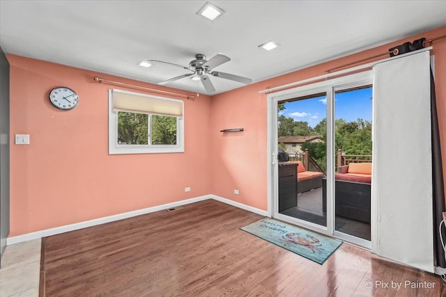 611 Brewster Ln, Schaumburg, IL 60193 - spare room featuring plenty of natural light, wood finished floors, a ceiling fan, and baseboards