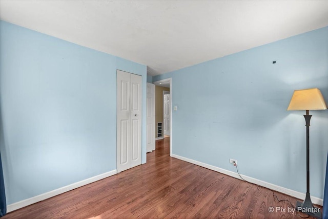 611 Brewster Ln, Schaumburg, IL 60193 - spare room with baseboards and wood finished floors