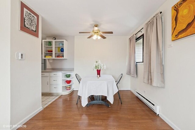 14747 Kenton Ave Unit 3B, Midlothian, IL 60445 - dining space with baseboard heating, a ceiling fan, light wood finished floors, and baseboards