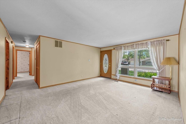 1434 Somerset Ln, Schaumburg, IL 60193 - unfurnished living room featuring light colored carpet, a textured ceiling, and baseboards