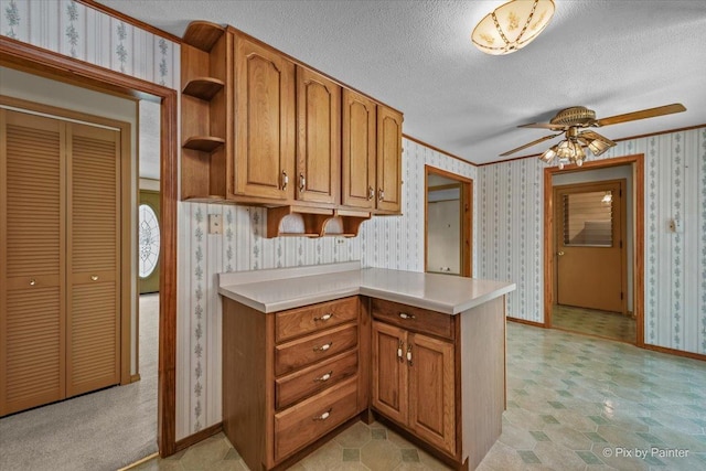 1434 Somerset Ln, Schaumburg, IL 60193 - kitchen featuring wallpapered walls, brown cabinets, baseboards, a textured ceiling, and light countertops
