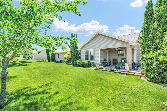 206 Wilsey Ln, Sidney, IL 61877 - back of house with ceiling fan, a yard, a patio area, and brick siding