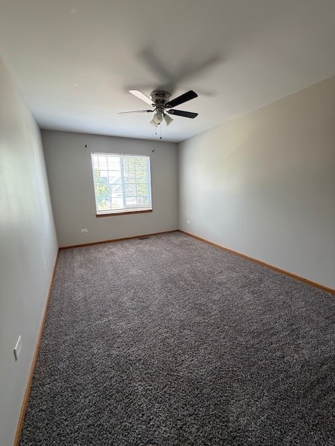 916 Bluegrass Ln, Plano, IL 60545 - unfurnished room with a ceiling fan, carpet floors, and baseboards