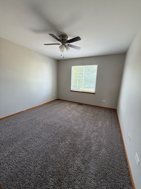 916 Bluegrass Ln, Plano, IL 60545 - spare room featuring carpet, a ceiling fan, and baseboards