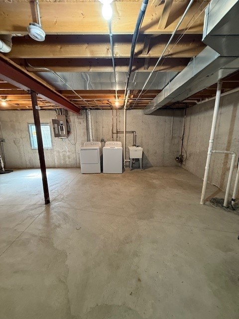 916 Bluegrass Ln, Plano, IL 60545 - basement with washing machine and clothes dryer, electric panel, and a sink
