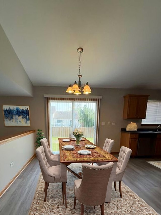 916 Bluegrass Ln, Plano, IL 60545 - dining space featuring a chandelier, wood finished floors, and baseboards