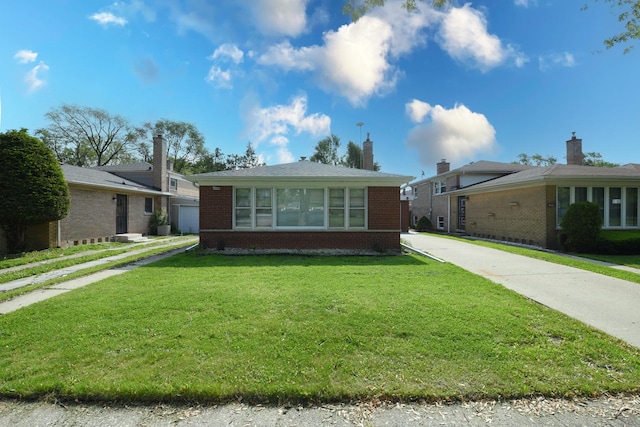 10945 S Lowe Ave, Chicago, IL 60628 - bungalow-style home with brick siding and a front yard