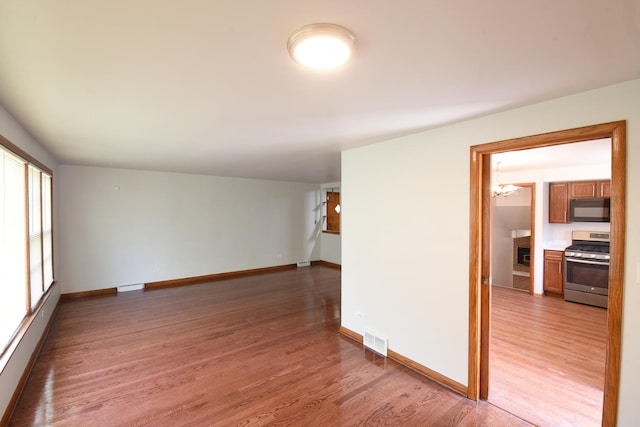 10945 S Lowe Ave, Chicago, IL 60628 - unfurnished room with light wood finished floors and baseboards
