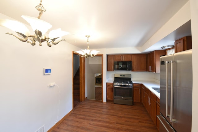 10945 S Lowe Ave, Chicago, IL 60628 - kitchen featuring stainless steel appliances, a chandelier, light countertops, dark wood-type flooring, and decorative light fixtures