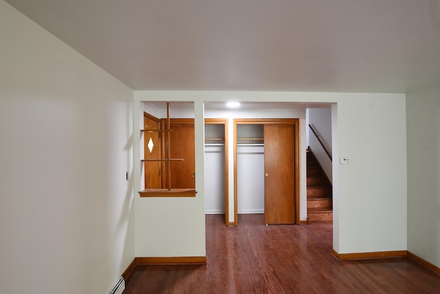 10945 S Lowe Ave, Chicago, IL 60628 - unfurnished bedroom featuring baseboards, wood finished floors, and multiple closets