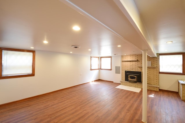 10945 S Lowe Ave, Chicago, IL 60628 - unfurnished living room with wood finished floors, a brick fireplace, and baseboards