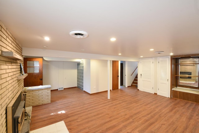 10945 S Lowe Ave, Chicago, IL 60628 - finished basement featuring wood finished floors, recessed lighting, stairway, and baseboards