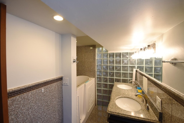 10945 S Lowe Ave, Chicago, IL 60628 - full bathroom featuring tile walls, a bathtub, double vanity, and wainscoting