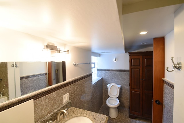 10945 S Lowe Ave, Chicago, IL 60628 - bathroom with tile walls, toilet, vanity, wainscoting, and recessed lighting