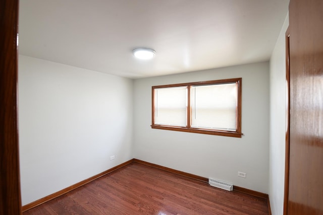 10945 S Lowe Ave, Chicago, IL 60628 - spare room featuring dark wood-style flooring and baseboards