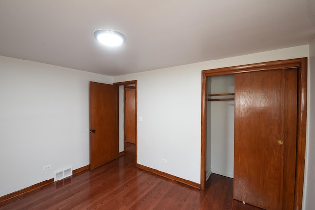 10945 S Lowe Ave, Chicago, IL 60628 - unfurnished bedroom with wood finished floors, a closet, and baseboards