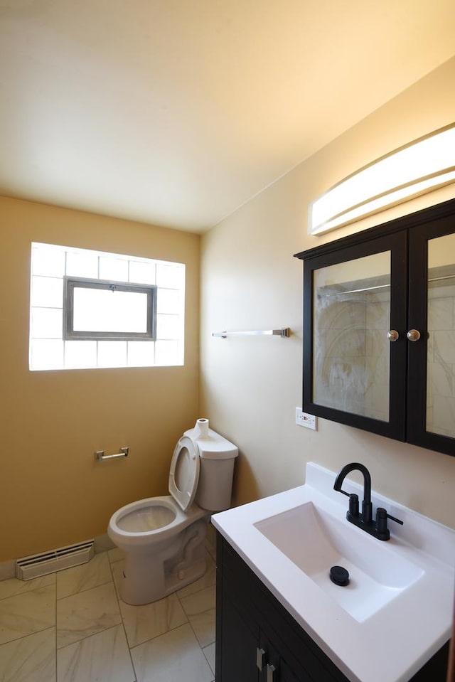 10945 S Lowe Ave, Chicago, IL 60628 - bathroom with vanity, toilet, marble look tile flooring, and baseboard heating