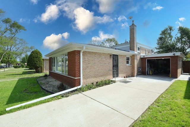 10945 S Lowe Ave, Chicago, IL 60628 - view of side of home featuring brick siding, a yard, driveway, and a chimney