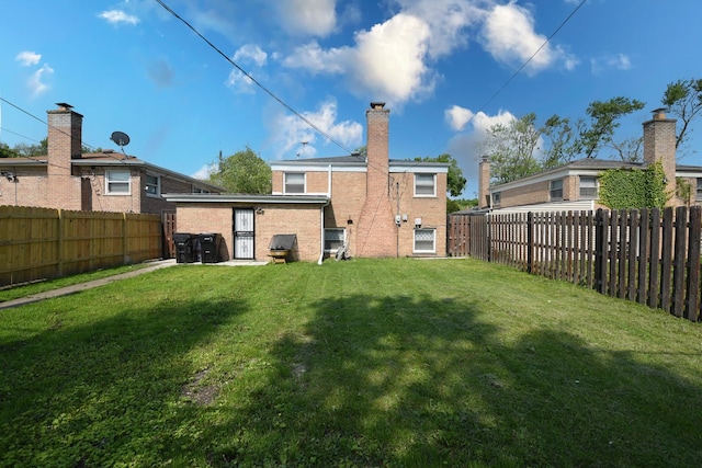 10945 S Lowe Ave, Chicago, IL 60628 - rear view of house with brick siding and a chimney