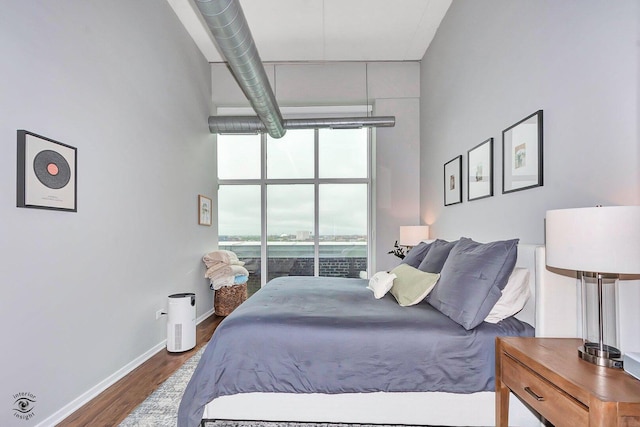 1645 W Ogden Ave Unit 722, Chicago, IL 60612 - bedroom with floor to ceiling windows, wood finished floors, and baseboards