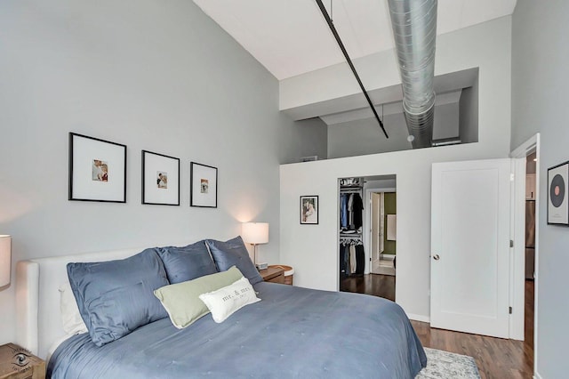 1645 W Ogden Ave Unit 722, Chicago, IL 60612 - bedroom with high vaulted ceiling, dark wood-style floors, and baseboards