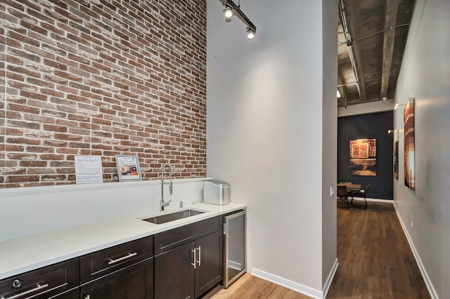 1645 W Ogden Ave Unit 722, Chicago, IL 60612 - bar featuring a sink, light wood-type flooring, brick wall, and baseboards