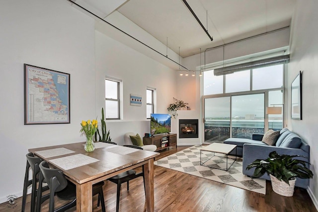1645 W Ogden Ave Unit 722, Chicago, IL 60612 - dining area with a towering ceiling, wood finished floors, and a glass covered fireplace