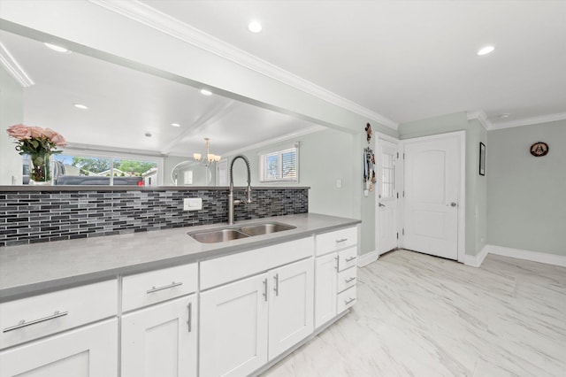 6315 W 83rd Pl, Burbank, IL 60459 - kitchen featuring decorative backsplash, white cabinets, a chandelier, light countertops, and light marble finish floors