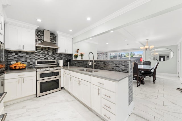 6315 W 83rd Pl, Burbank, IL 60459 - kitchen with range with two ovens, wall chimney range hood, a peninsula, a chandelier, and tasteful backsplash
