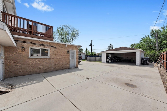 6315 W 83rd Pl, Burbank, IL 60459 - view of side of home featuring a balcony, brick siding, a garage, and an outbuilding
