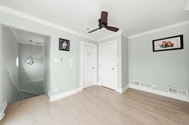 6315 W 83rd Pl, Burbank, IL 60459 - spare room with wood finished floors, crown molding, a ceiling fan, and a chandelier