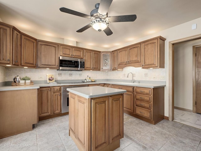 941 Meadowcrest Rd, La Grange Park, IL 60526 - kitchen featuring stainless steel microwave, electric stovetop, a sink, a ceiling fan, and backsplash