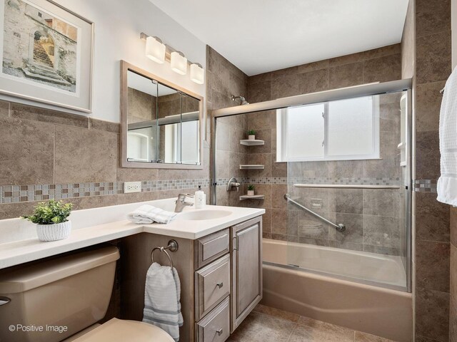941 Meadowcrest Rd, La Grange Park, IL 60526 - bathroom with vanity, enclosed tub / shower combo, toilet, tile walls, and tile patterned floors