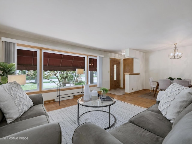 941 Meadowcrest Rd, La Grange Park, IL 60526 - living room featuring a chandelier, light wood finished floors, and baseboards