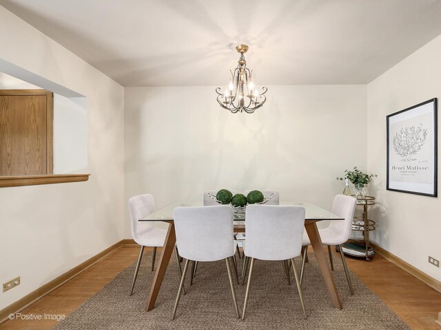 941 Meadowcrest Rd, La Grange Park, IL 60526 - dining space featuring a chandelier, wood finished floors, and baseboards