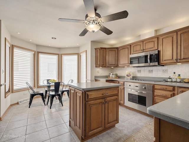 941 Meadowcrest Rd, La Grange Park, IL 60526 - kitchen featuring appliances with stainless steel finishes, brown cabinetry, backsplash, light tile patterned floors, and recessed lighting