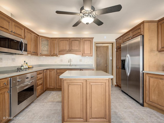 941 Meadowcrest Rd, La Grange Park, IL 60526 - kitchen featuring stainless steel appliances, a sink, light countertops, a kitchen island, and backsplash