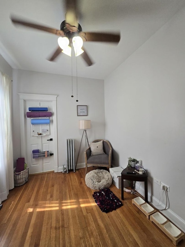 1055 E Hyde Park Blvd Unit 3, Chicago, IL 60615 - sitting room with radiator, ceiling fan, wood finished floors, and baseboards