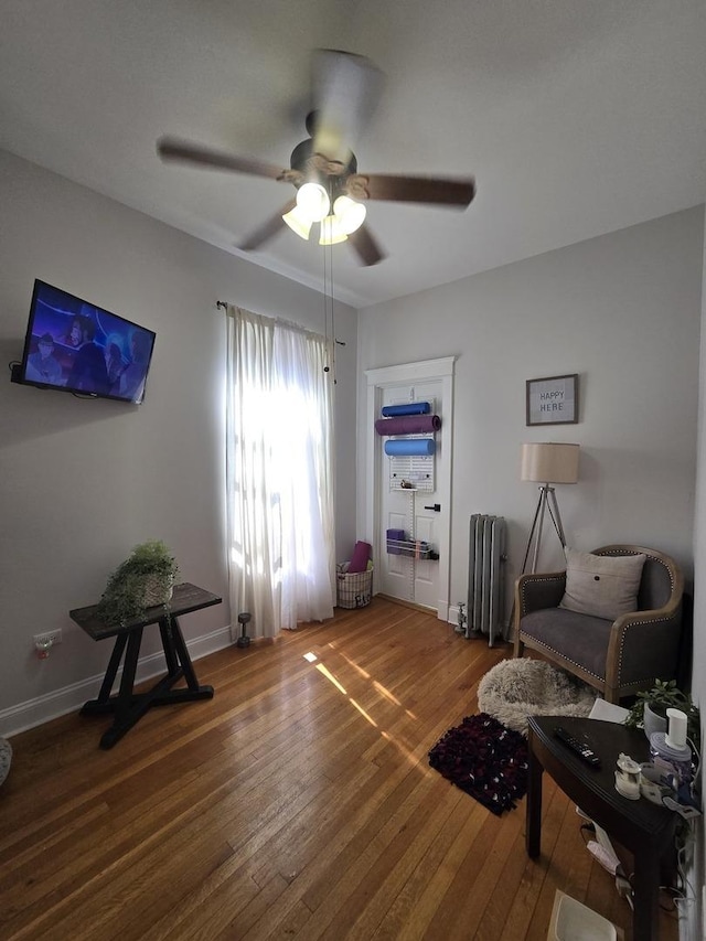1055 E Hyde Park Blvd Unit 3, Chicago, IL 60615 - living area with radiator heating unit, a ceiling fan, hardwood / wood-style floors, and baseboards