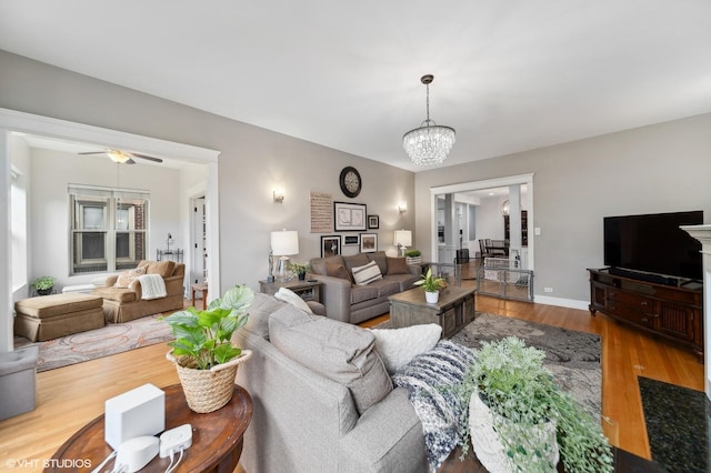 1055 E Hyde Park Blvd Unit 3, Chicago, IL 60615 - living area featuring wood finished floors, a chandelier, ceiling fan, and baseboards