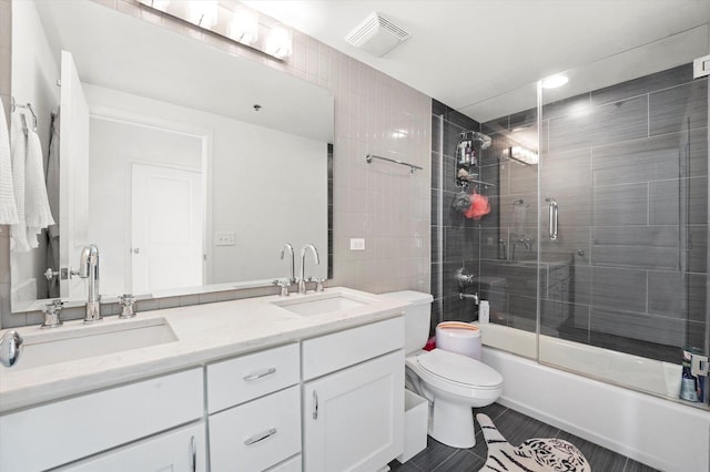50 E 16th St Unit 1206, Chicago, IL 60616 - full bathroom with double vanity, toilet, combined bath / shower with glass door, and tile patterned flooring