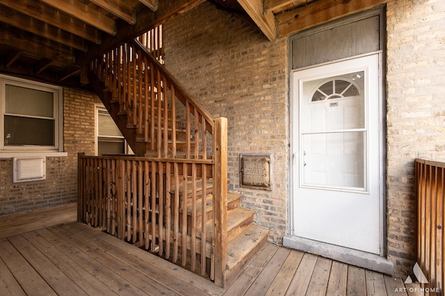 4855 W Roscoe St Unit 1, Chicago, IL 60641 - view of exterior entry featuring brick siding and a deck