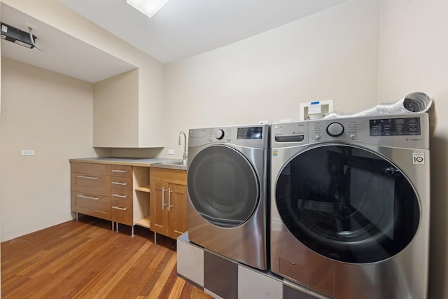 16W307 95th Pl, Burr Ridge, IL 60527 - laundry area featuring washer and clothes dryer, light wood-style floors, and cabinet space