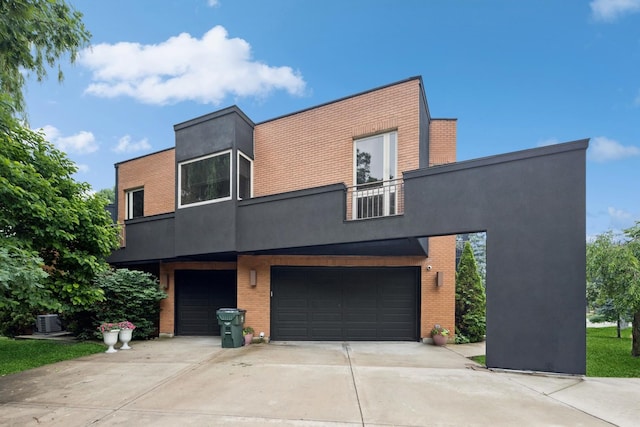 16W307 95th Pl, Burr Ridge, IL 60527 - contemporary house featuring an attached garage, brick siding, driveway, stucco siding, and a balcony
