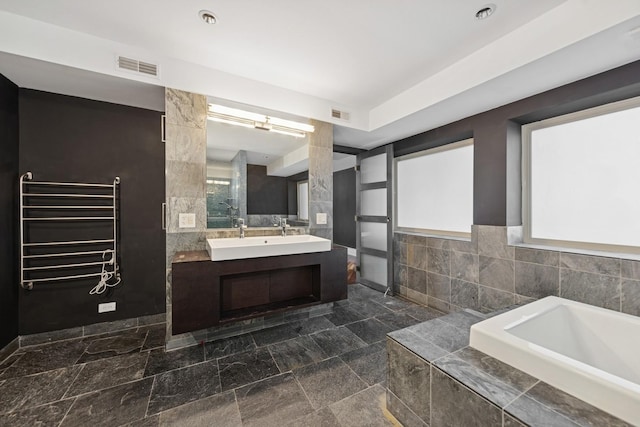 16W307 95th Pl, Burr Ridge, IL 60527 - bathroom featuring tile walls, radiator heating unit, a garden tub, vanity, and a towel warming rack