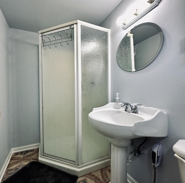 1330 Todd Farm Dr, Elgin, IL 60123 - bathroom featuring a shower stall, baseboards, and toilet