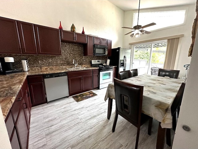 1330 Todd Farm Dr, Elgin, IL 60123 - kitchen featuring stainless steel appliances, a sink, backsplash, a high ceiling, and a ceiling fan