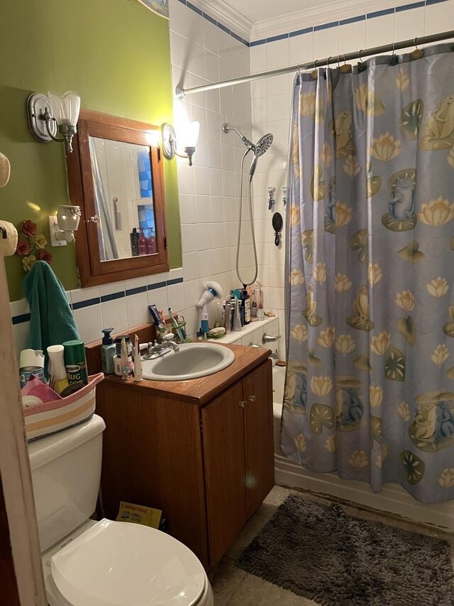 316 E Jefferson St, Freeport, IL 61032 - bathroom with toilet, vanity, shower / bathtub combination with curtain, tile walls, and ornamental molding